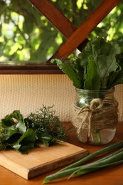 Photo of Different fresh green herbs on window sill indoors