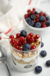 Photo of Delicious yogurt parfait with fresh berries on white table, closeup