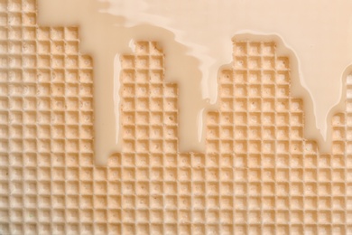 Hot white chocolate on wafer, closeup. Crispy food