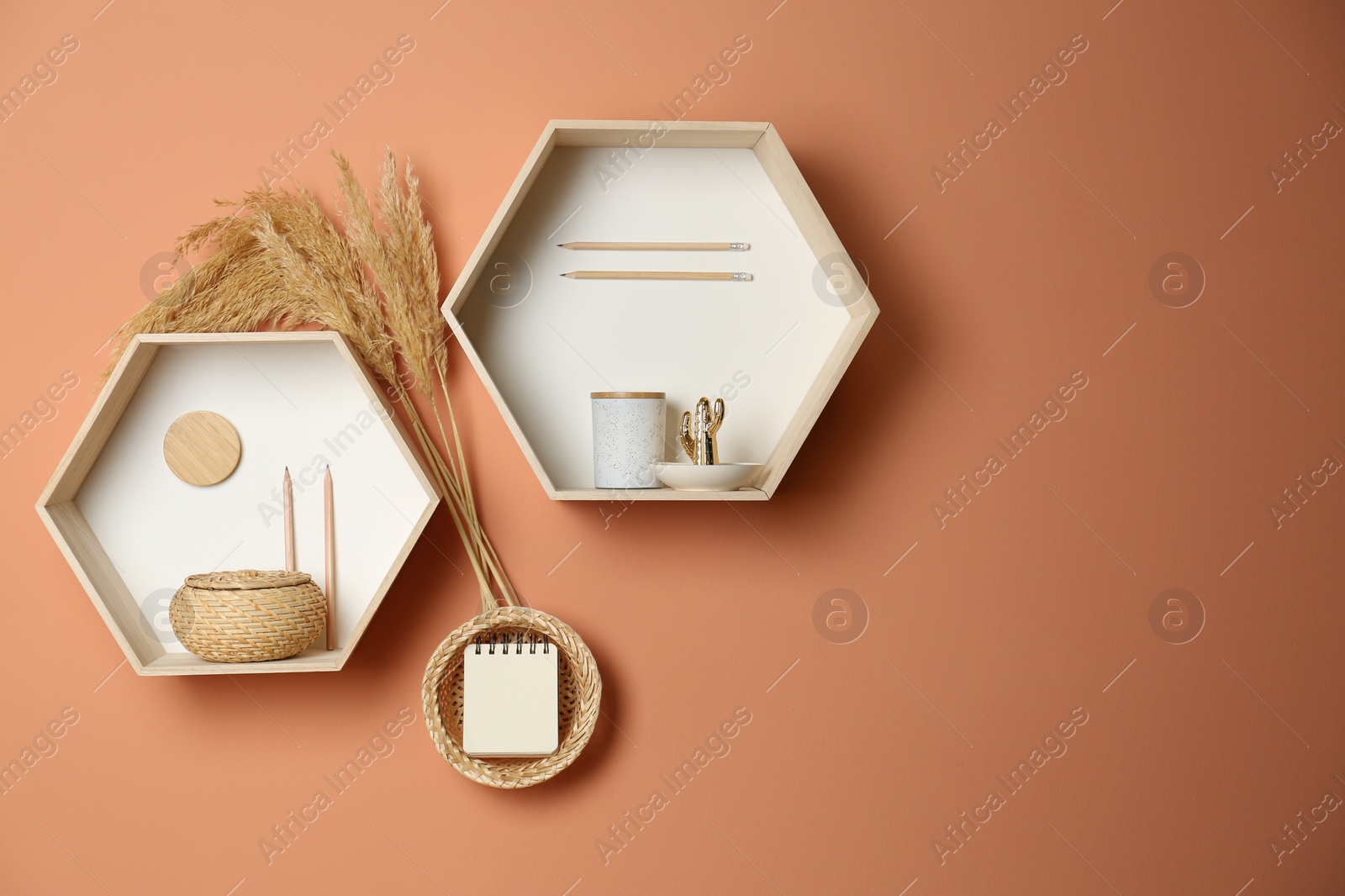 Photo of Shelves with stylish decorations on brown wall. Interior design