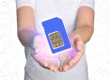 Woman demonstrating SIM card on white background, closeup 
