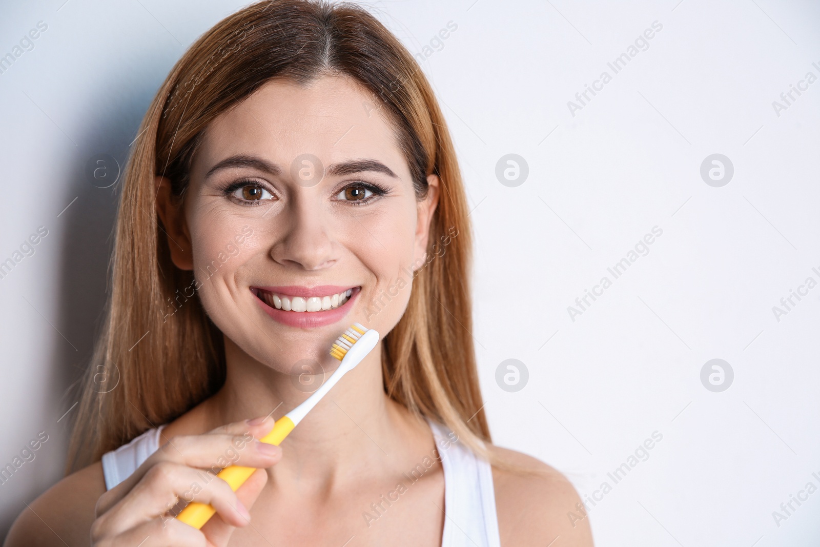 Photo of Portrait of woman with toothbrush on white background. Space for text