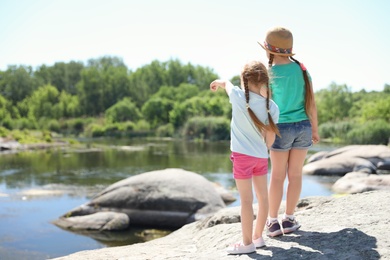 Little girls at riverside. Summer camp