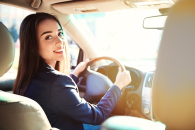 Photo of Young businesswoman on driver's seat of car