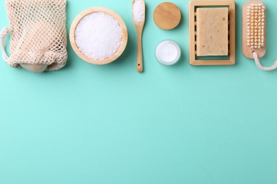 Jar of cream and body care products on turquoise background, flat lay. Space for text