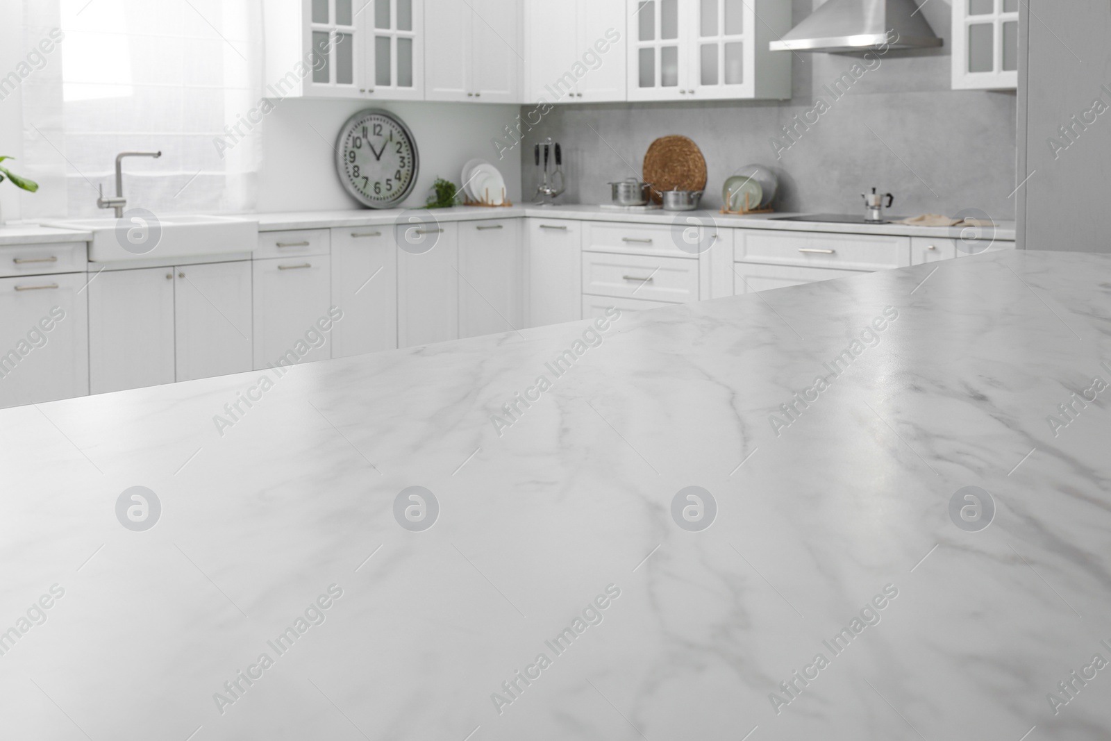 Photo of Stylish white marble countertop in kitchen. Interior design