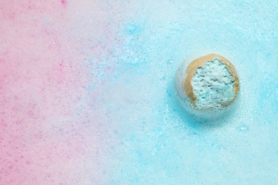 Light blue bath bomb dissolving in water. Space for text