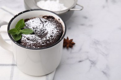 Tasty chocolate mug pie on white marble table, space for text. Microwave cake recipe