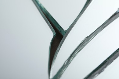 Broken mirror with many cracks as background, closeup view