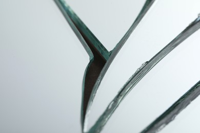 Photo of Broken mirror with many cracks as background, closeup view