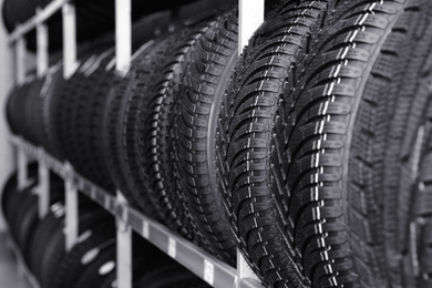 Photo of Car tires on rack in auto store, closeup