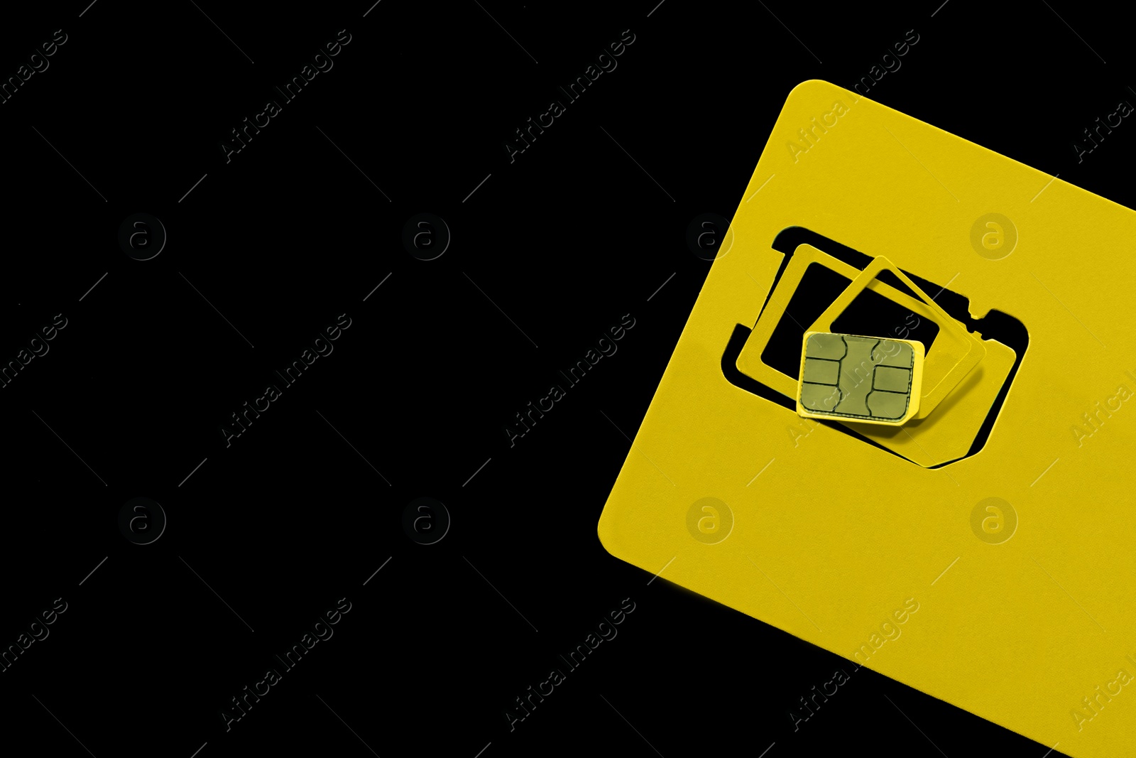 Photo of Multi SIM card on black background, top view. Space for text