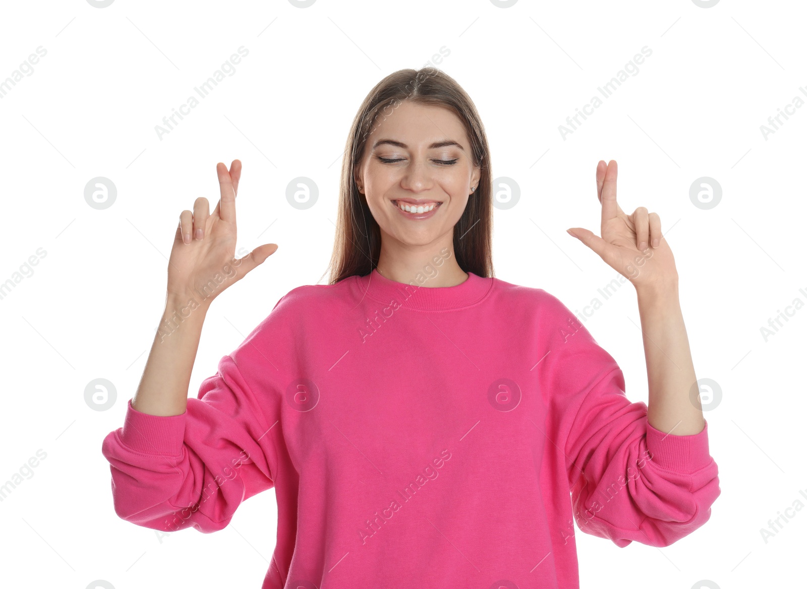 Photo of Woman with crossed fingers on white background. Superstition concept