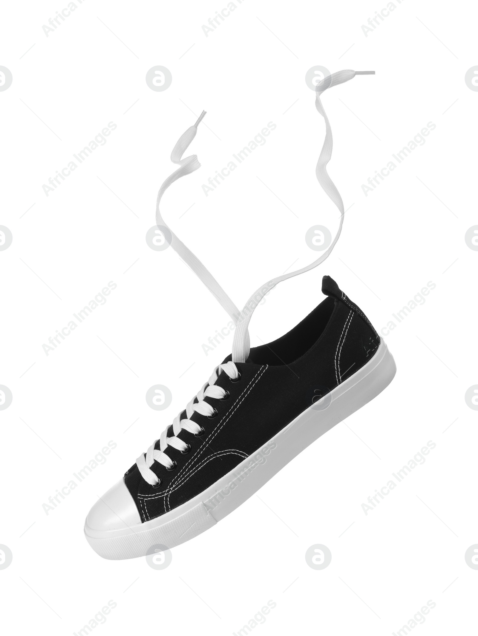 Photo of One black classic old school sneaker isolated on white