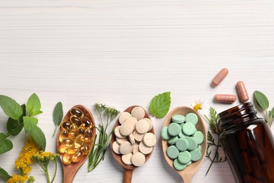 Photo of Different pills, herbs and flowers on white wooden table, flat lay with space for text. Dietary supplements