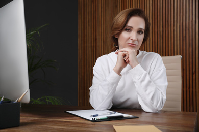 Photo of Portrait of psychotherapist at table in office