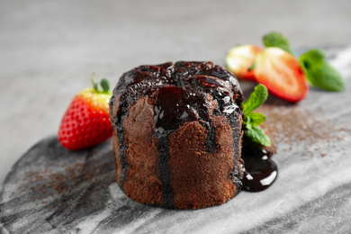 Delicious warm chocolate lava cake on marble board, closeup