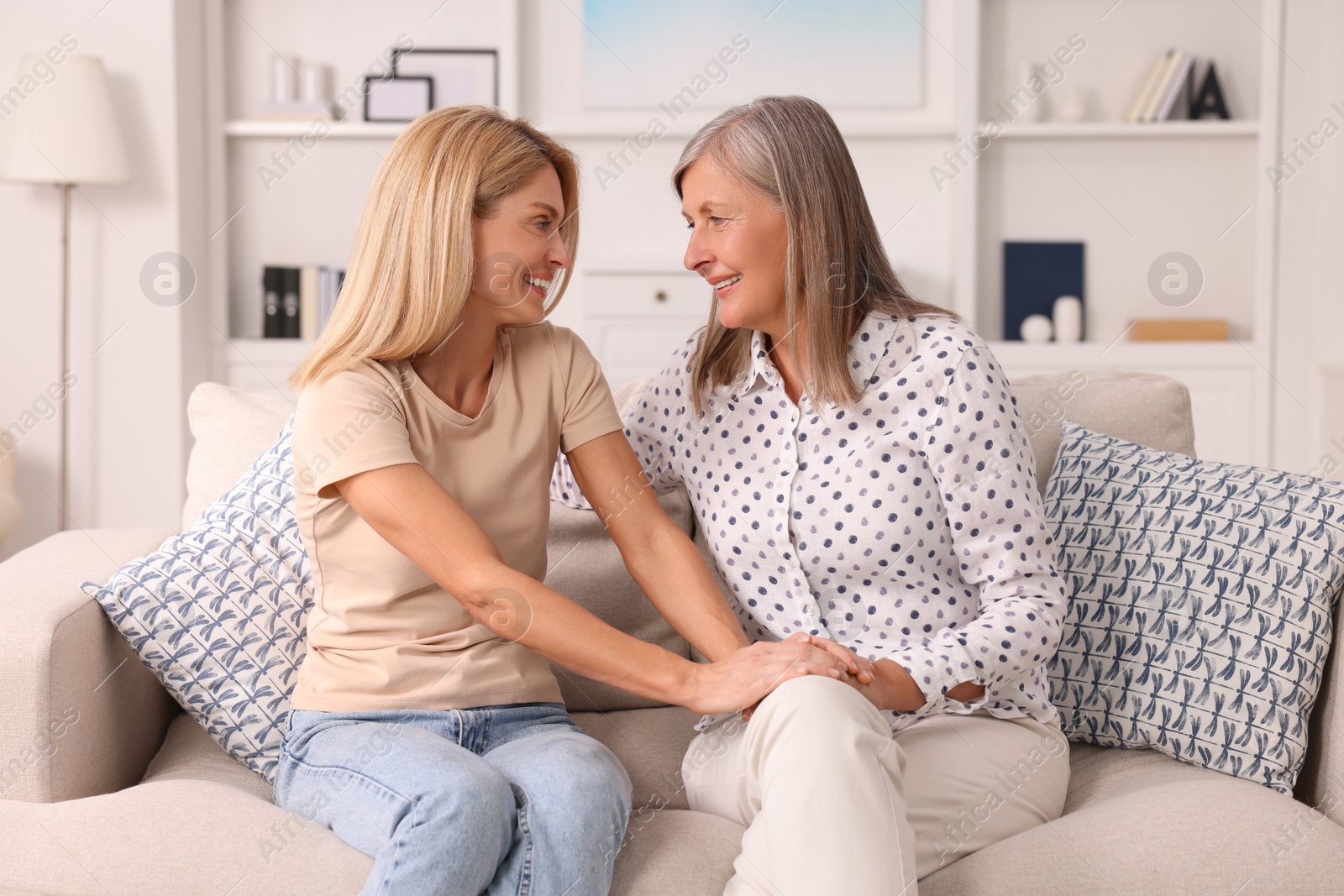 Photo of Happy mature mother and her daughter spending time together at home