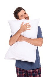 Photo of Handsome man hugging soft pillow on white background