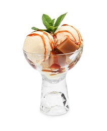 Photo of Delicious ice cream with caramel and mint in glass dessert bowl on white background
