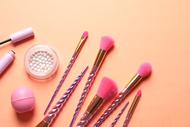 Photo of Flat lay composition with makeup brushes on orange background
