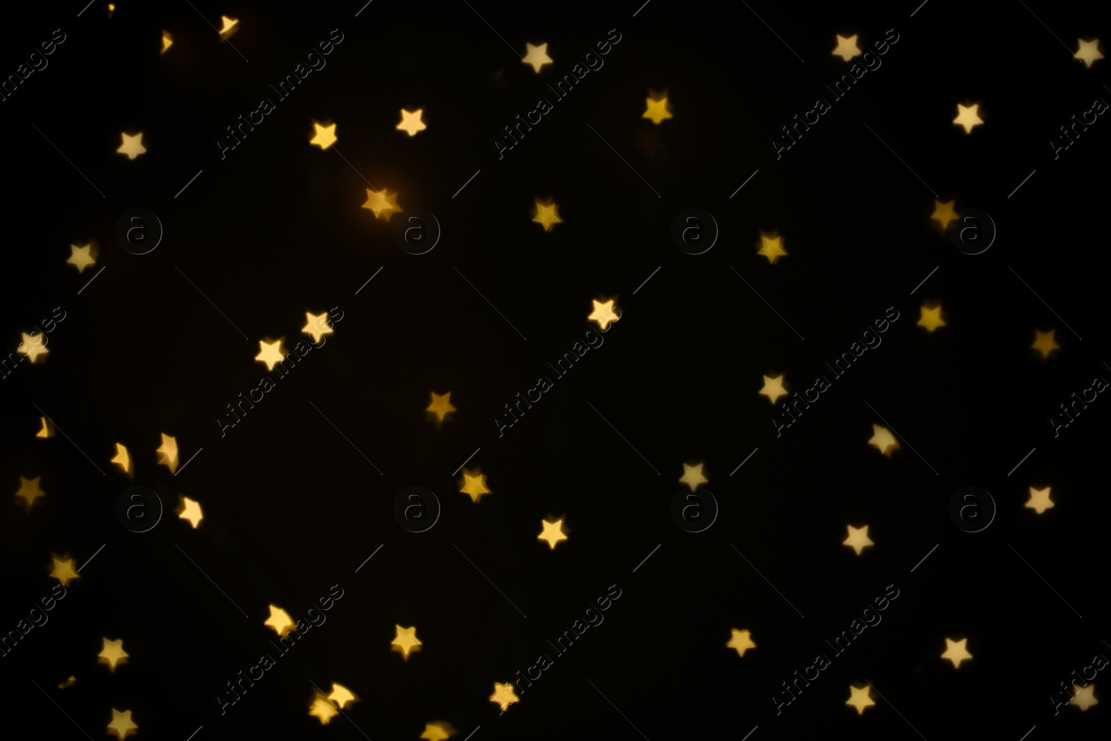 Photo of Beautiful star shaped lights on black background