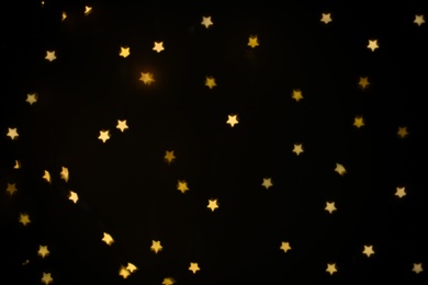 Photo of Beautiful star shaped lights on black background