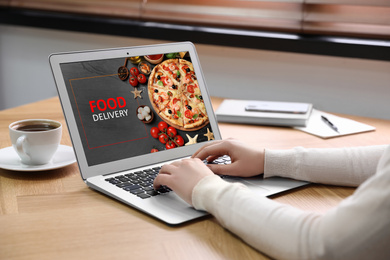 Image of Woman using laptop for online food order during quarantine, closeup. Delivery service