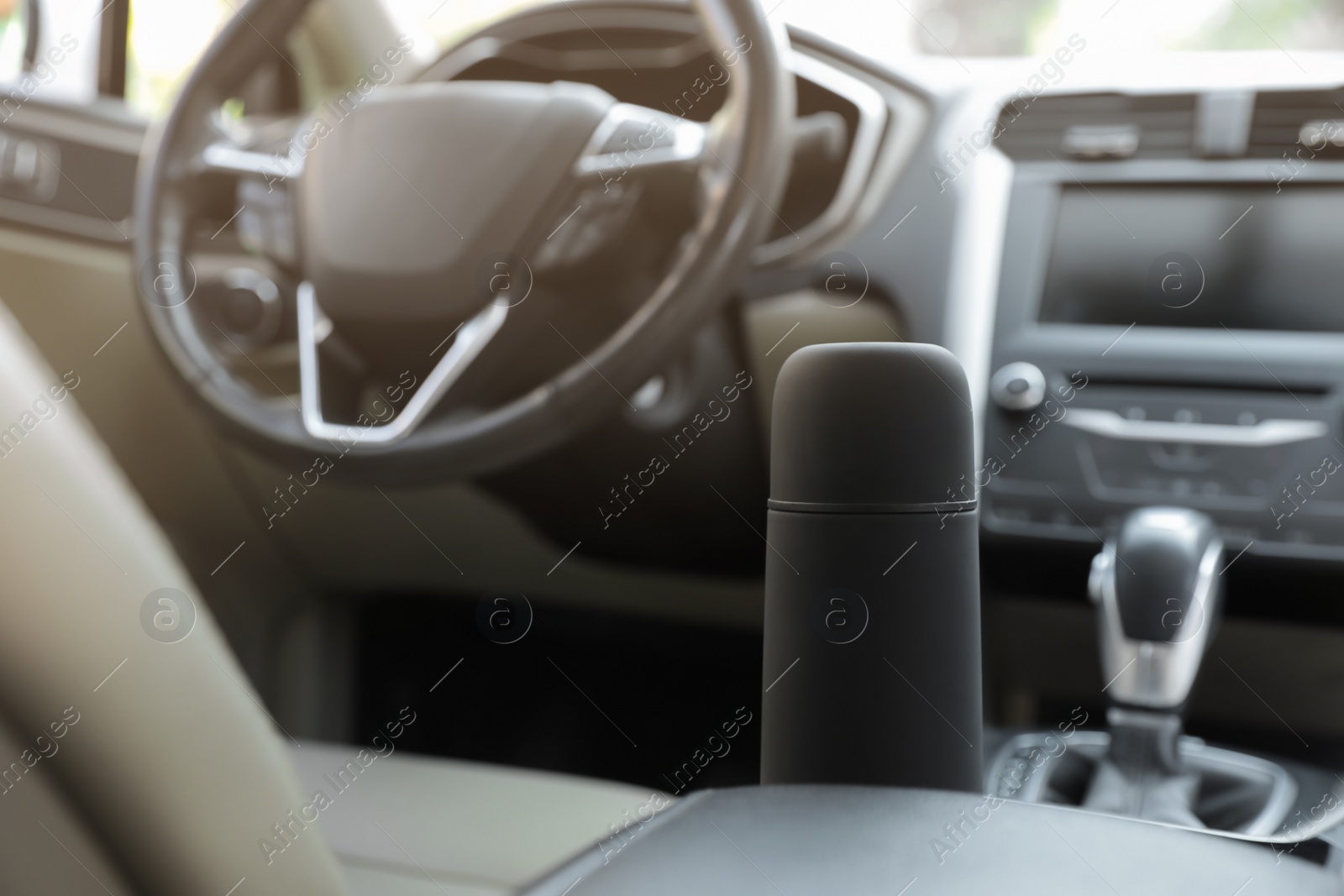 Photo of Black thermos in holder inside of car