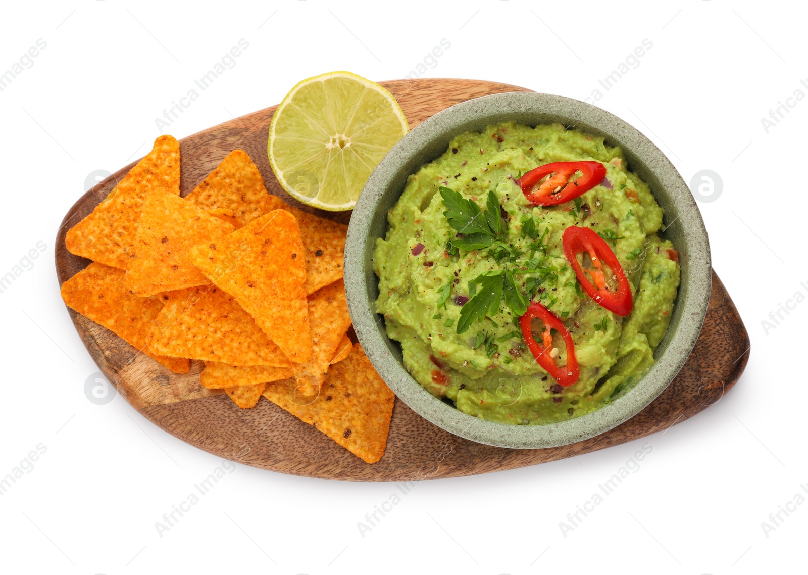 Photo of Bowl of delicious guacamole, lime and nachos chips isolated on white, top view