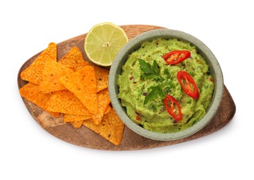 Photo of Bowl of delicious guacamole, lime and nachos chips isolated on white, top view