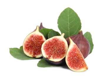 Photo of Fresh juicy purple figs and green leaves on white background