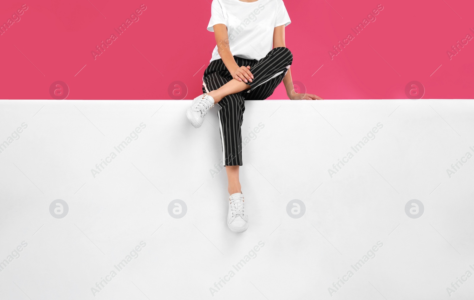 Photo of Woman wearing stylish shoes on color background, closeup