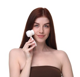 Washing face. Young woman with cleansing brush on white background