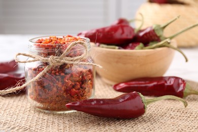 Chili pepper flakes and pods on table