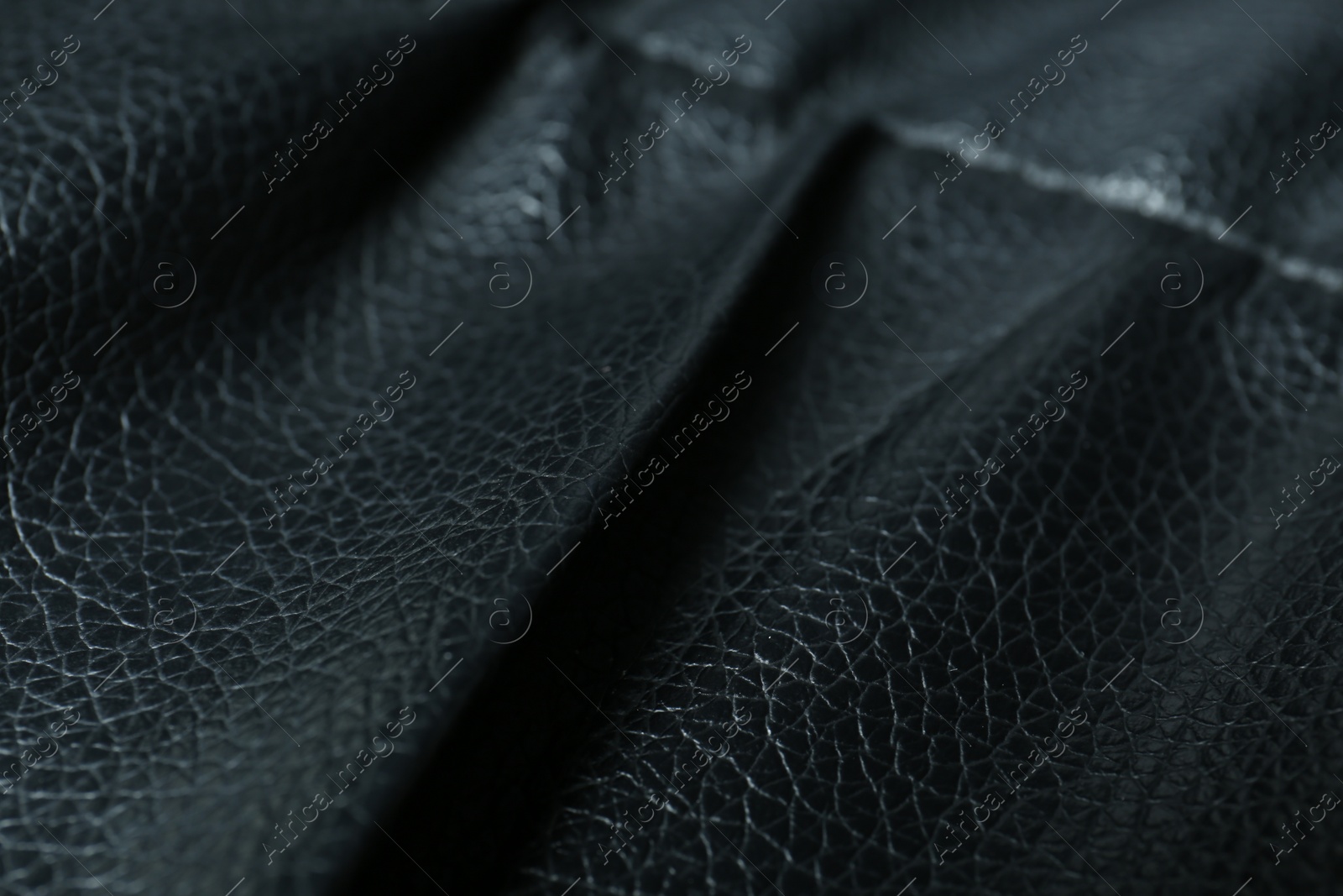 Photo of Black leather with seam as background, closeup