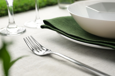 Photo of Elegant fork on table, closeup. Festive setting