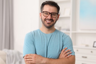 Photo of Portrait of happy man in stylish glasses at home