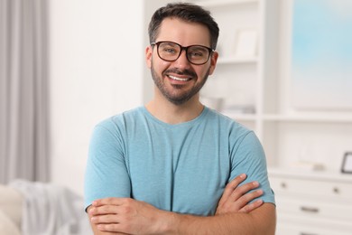 Portrait of happy man in stylish glasses at home