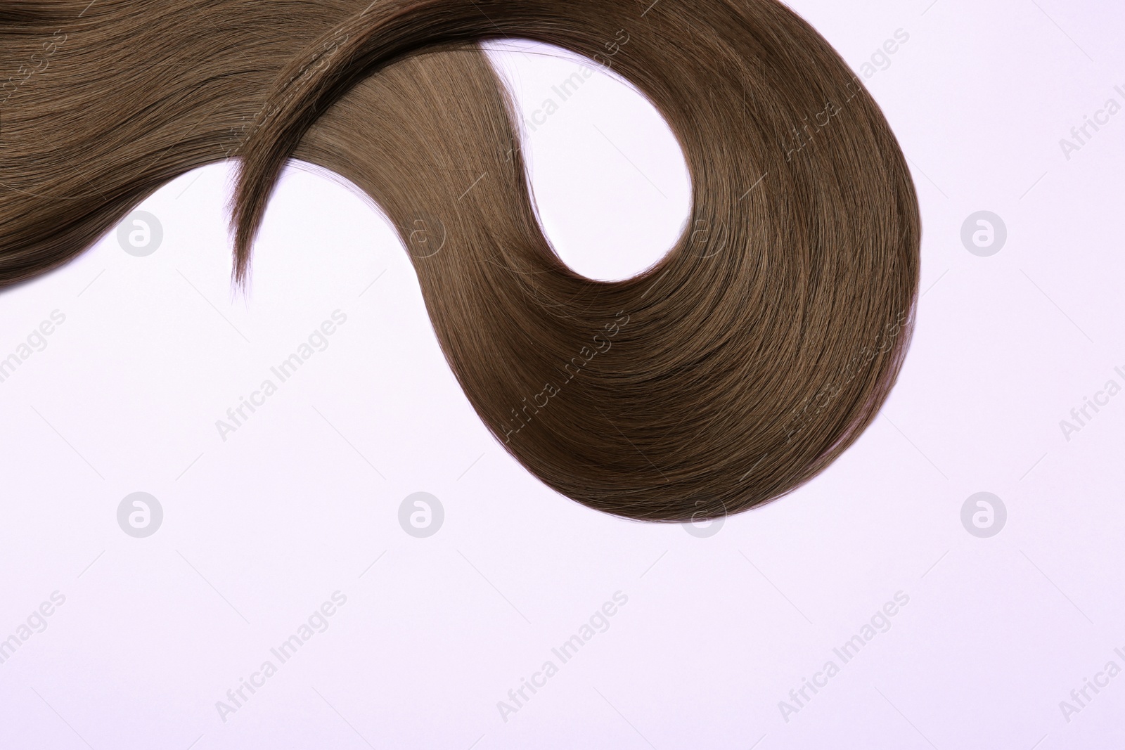 Photo of Beautiful brown straight hair on light background, space for text