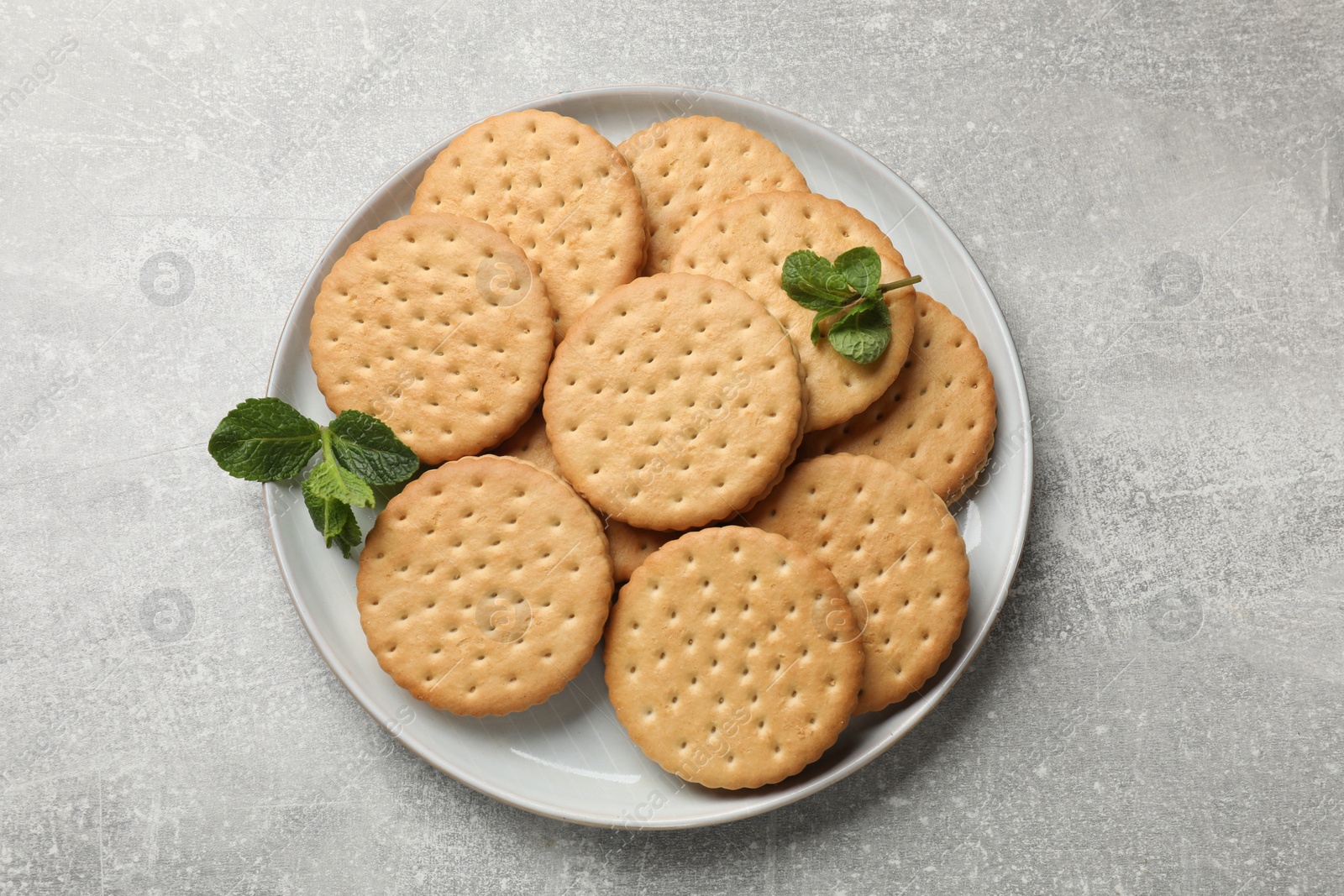 Photo of Tasty sandwich cookies on light gray textured table, top view