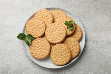 Tasty sandwich cookies on light gray textured table, top view