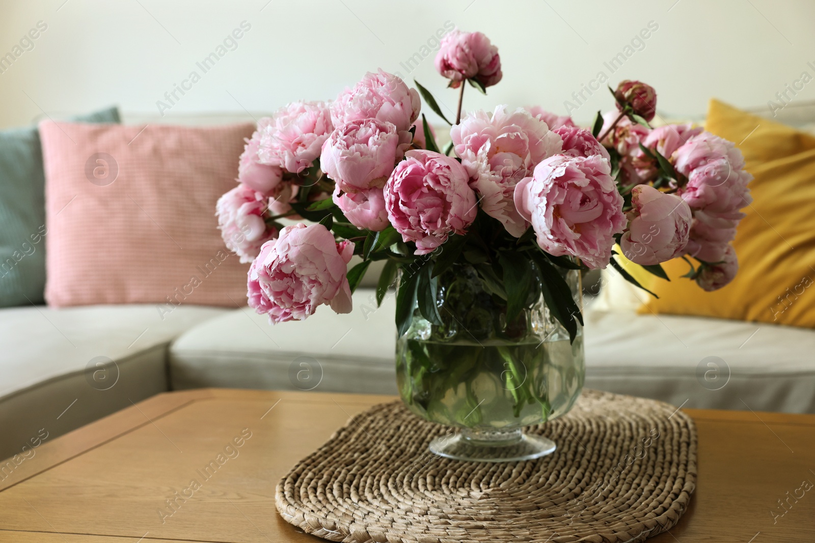 Photo of Beautiful pink peonies in vase on table at home. Interior design