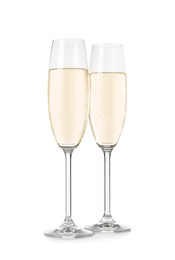 Glasses of sparkling wine on white background