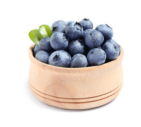 Fresh ripe blueberries in wooden bowl on white background