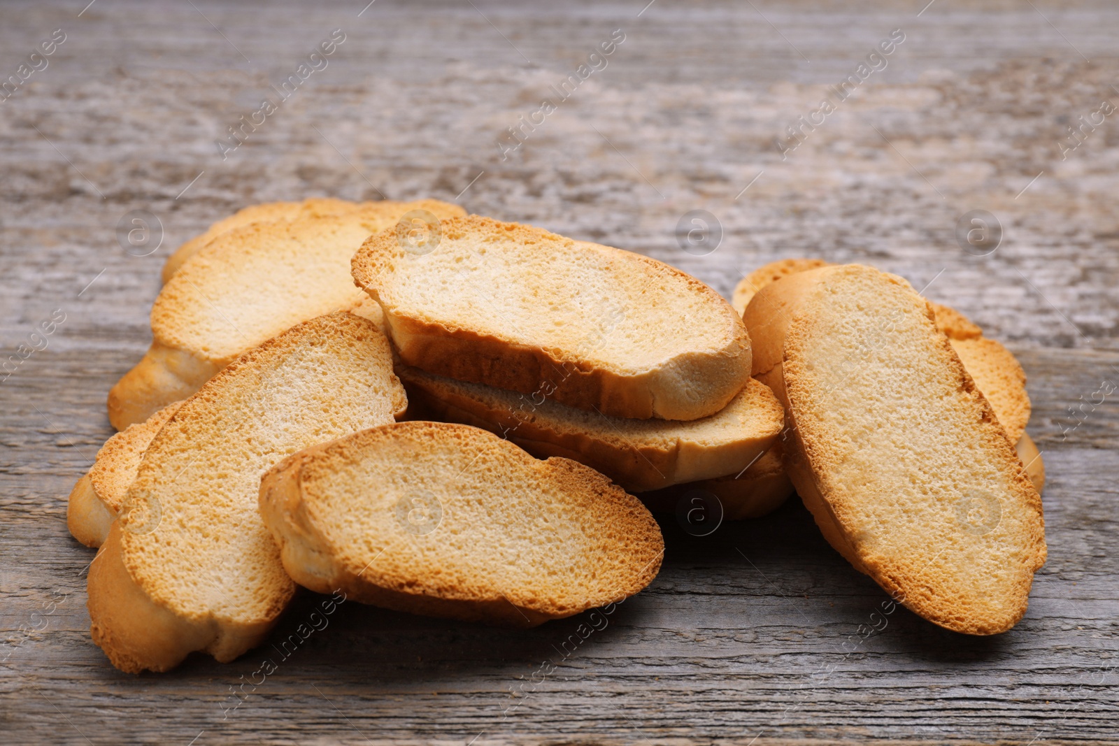 Photo of Tasty hard chuck crackers on wooden table