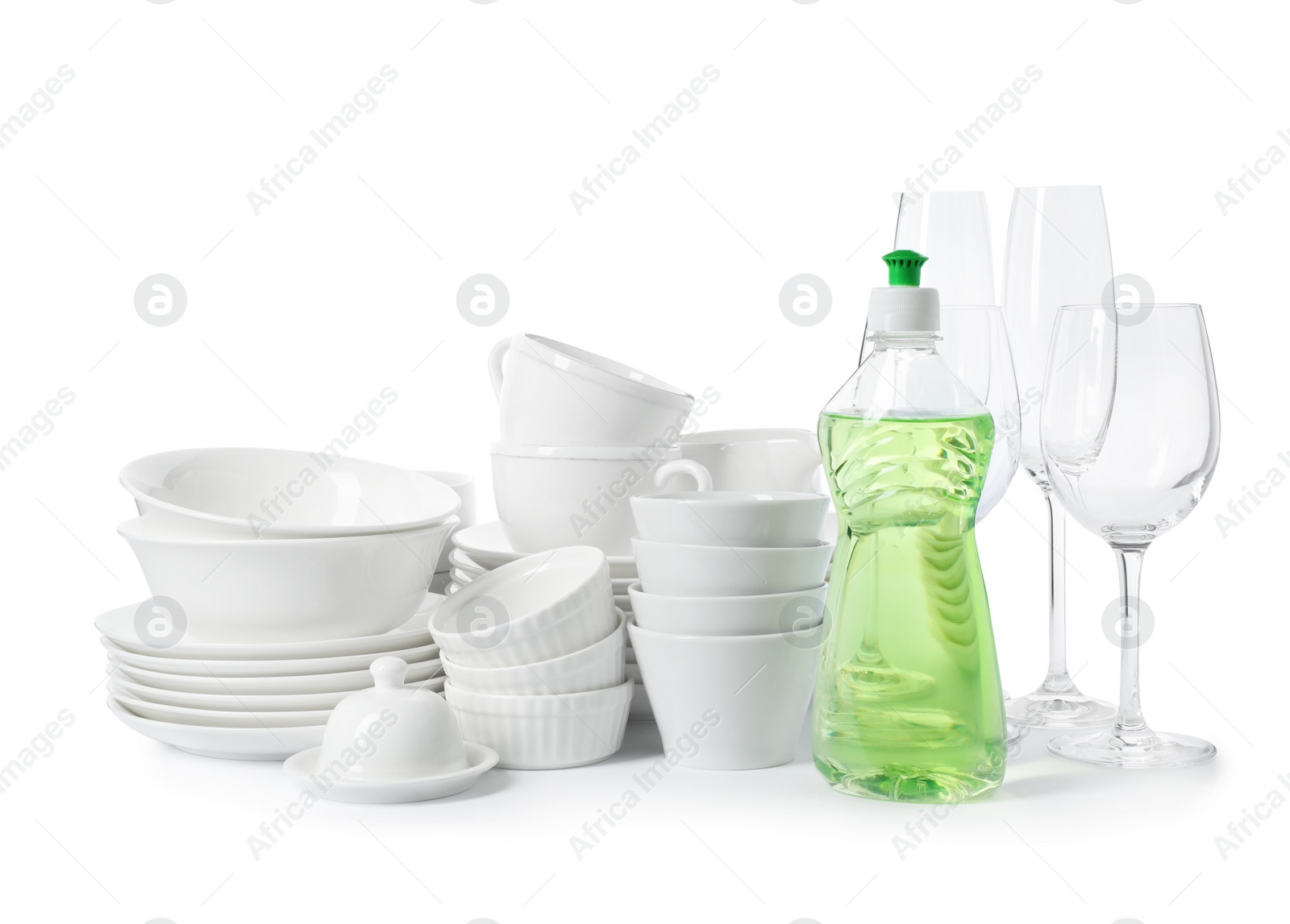 Photo of Clean tableware and bottle of detergent on white background. Washing dishes