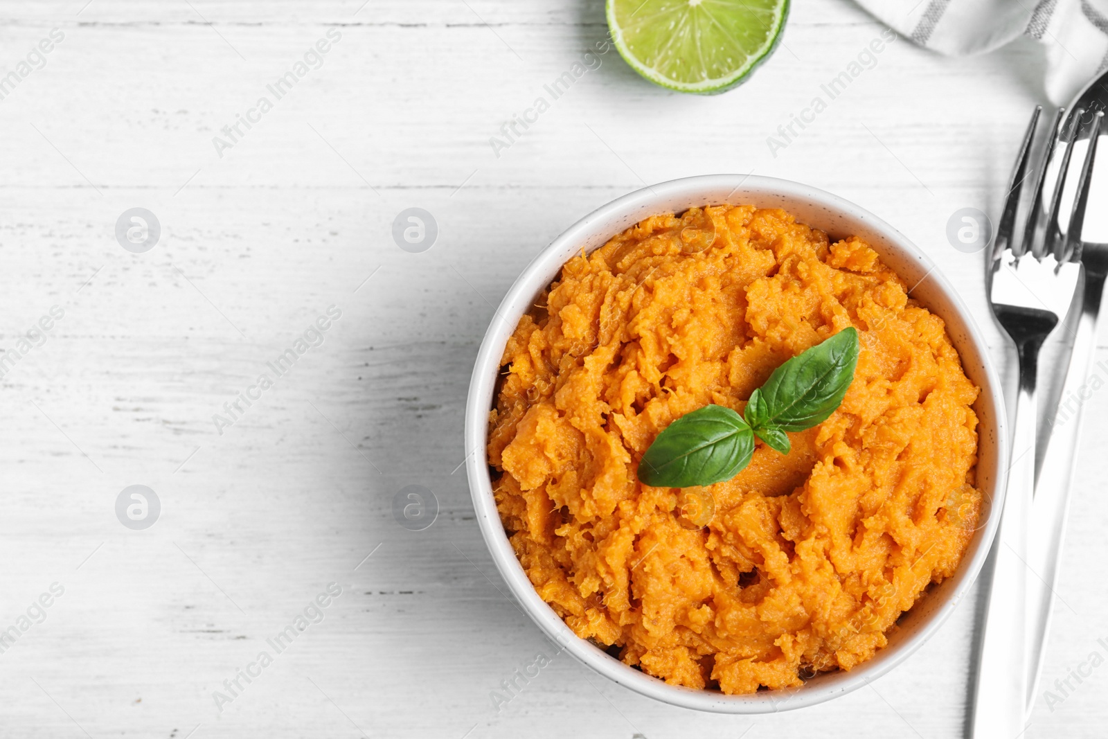 Photo of Flat lay composition with mashed sweet potatoes on wooden background, space for text