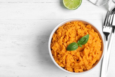 Photo of Flat lay composition with mashed sweet potatoes on wooden background, space for text