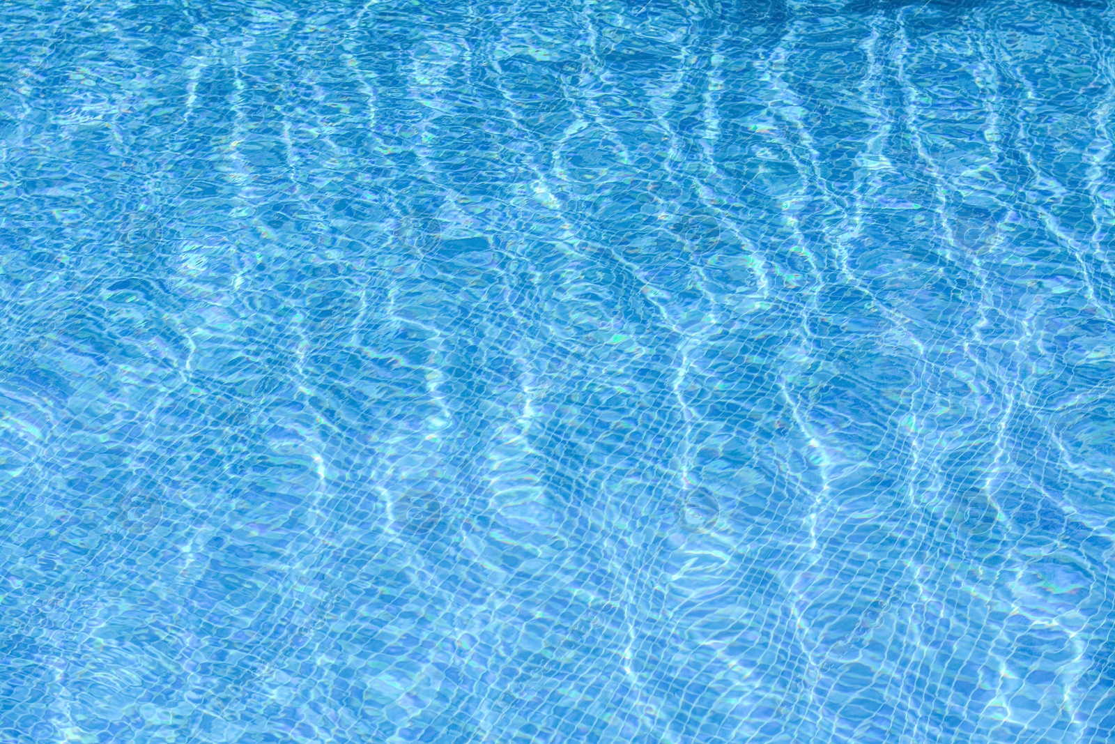 Photo of Clear refreshing water in swimming pool on sunny day, closeup